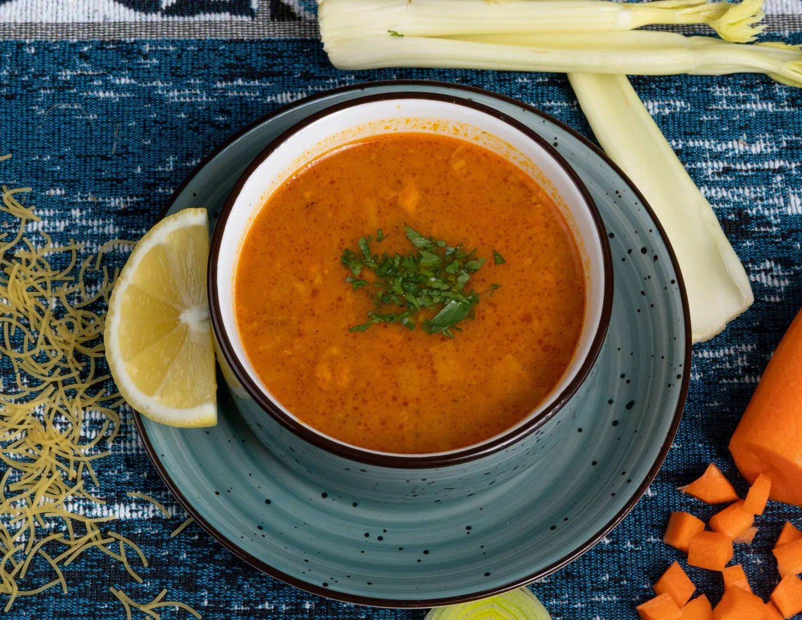 Bowl of harira, tomato, lentil and chickpea soup, served with lemon