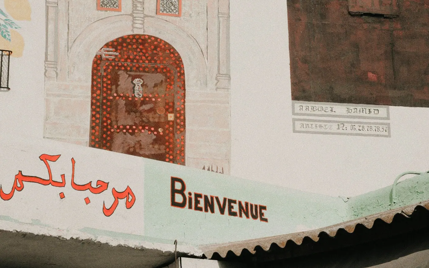 Entrance to a shopping lane with the word "Bienvenue" painted above