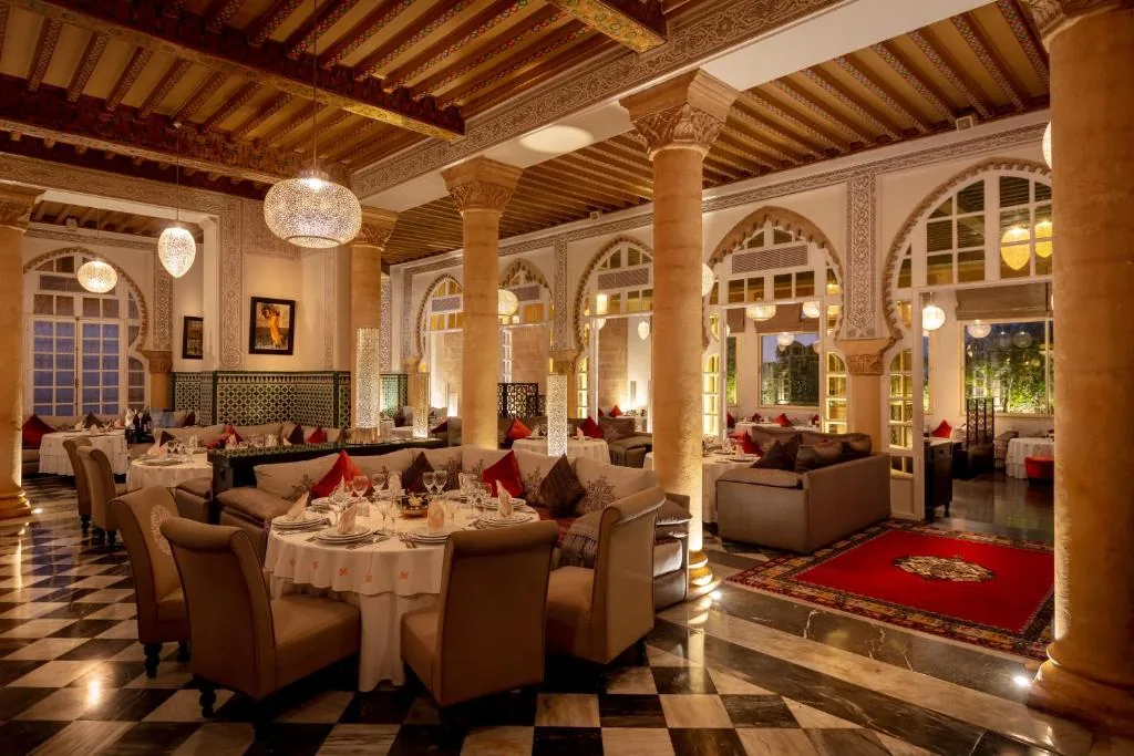 Large room with columns and a carved wooden ceiling, with a black-and-white checkerboard floor
